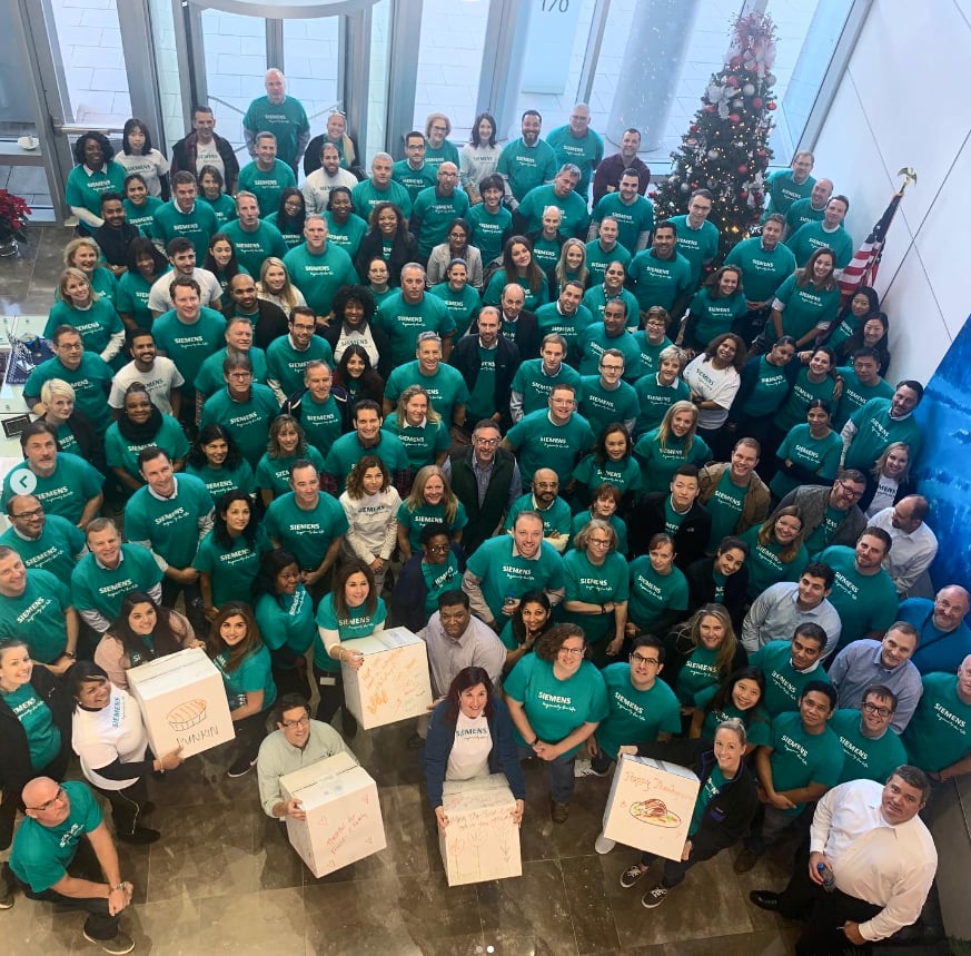 Large team with matching t shirts and donation boxes